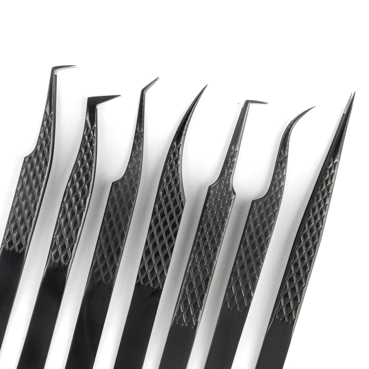 Close-up of COMELYLASH black lash extension tweezers with different tip shapes