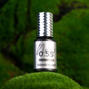 COMELYLASH all-climate GV2 lash adhesive bottle on green moss
