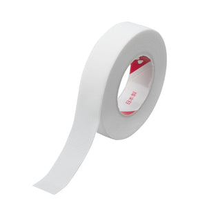 White Japanese lash tape roll with a perforated surface and unrolled strip